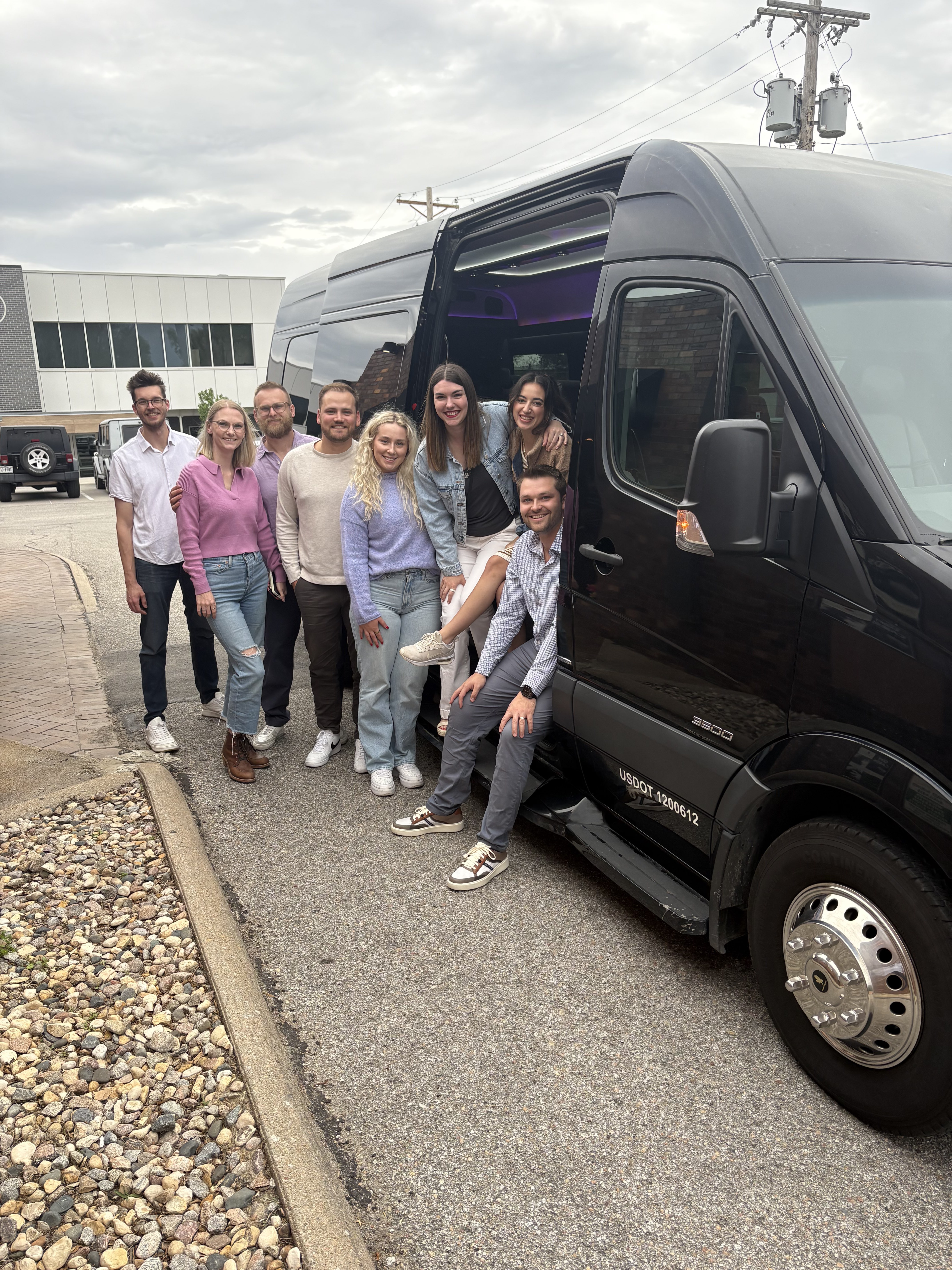 Group of friends posed beside the VET'd Transportation Sprinter